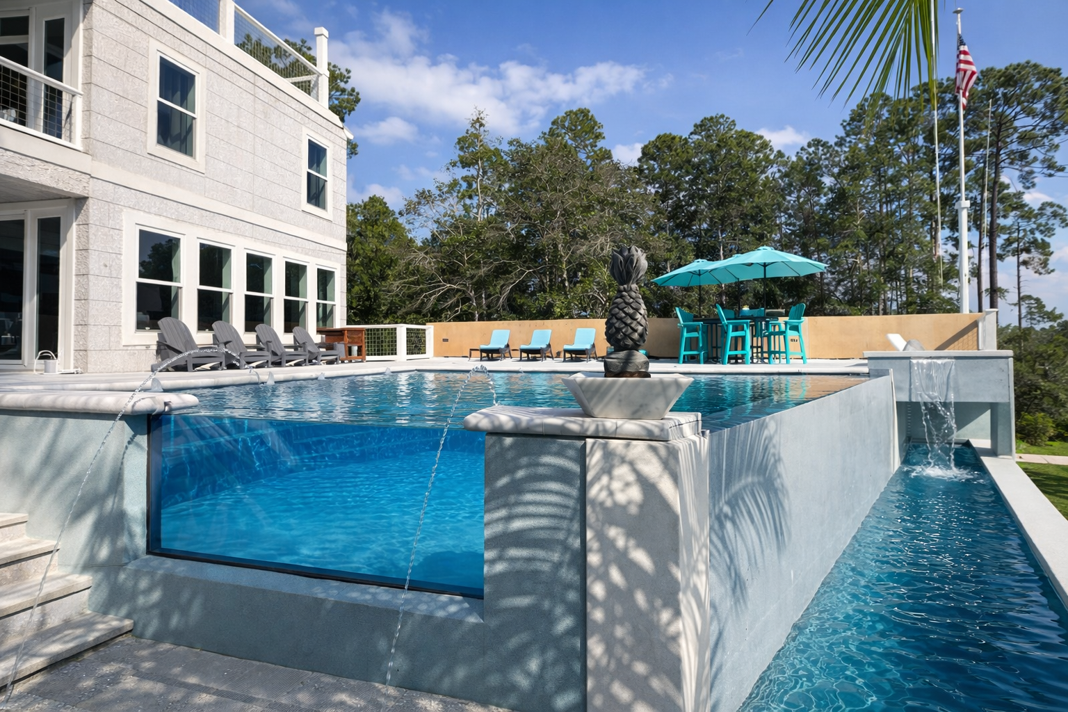 Award-winning Harbor View Oasis ICF pool with infinity edge, waterfalls, and glass wall features